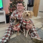 night of lights man with dogs in matching plaid